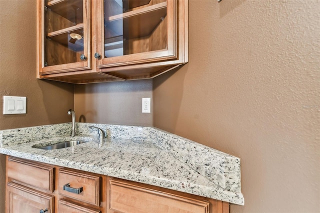 details with a textured wall and a sink