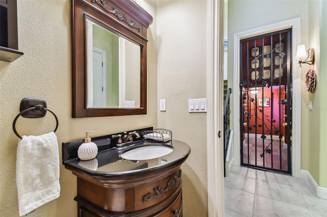 12709 Mannhurst Oak Ln, Lithia, FL 33547 - bathroom featuring tile patterned flooring, vanity, and a textured wall