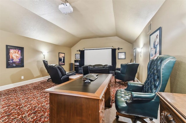 office space with a textured ceiling, light carpet, visible vents, baseboards, and vaulted ceiling