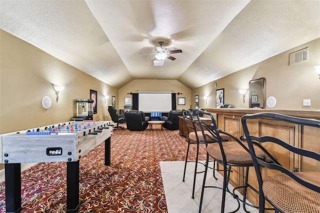 rec room with ceiling fan, lofted ceiling, and light carpet