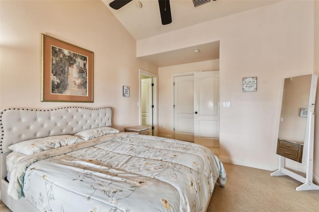 bedroom with light carpet, a closet, vaulted ceiling, and ceiling fan