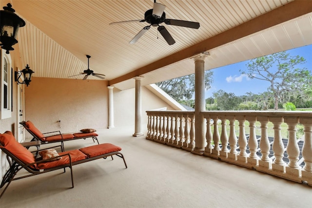 view of patio with ceiling fan and a balcony