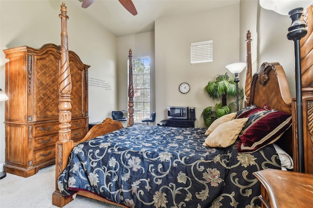 bedroom featuring light carpet, a ceiling fan, and lofted ceiling