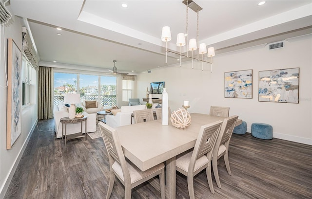 dining space with ceiling fan with notable chandelier and dark wood-type flooring