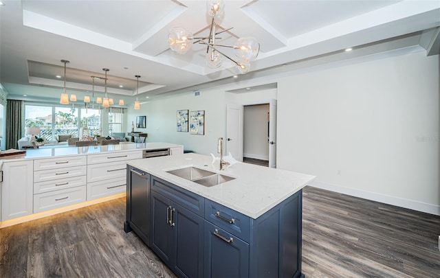 kitchen featuring white cabinets, a raised ceiling, sink, hanging light fixtures, and dark hardwood / wood-style flooring