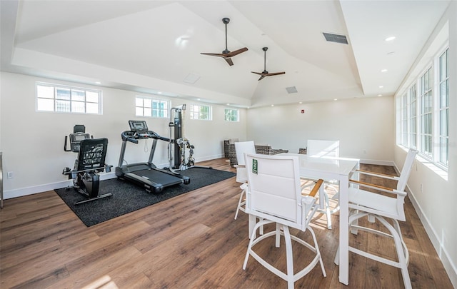 workout room with hardwood / wood-style flooring, ceiling fan, and lofted ceiling