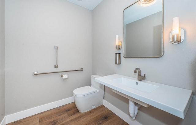 bathroom with toilet and wood-type flooring