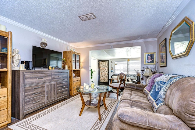 living room featuring a textured ceiling, wood-type flooring, and crown molding