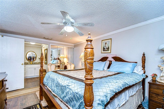 bedroom featuring dark hardwood / wood-style flooring, ornamental molding, a textured ceiling, ceiling fan, and a closet