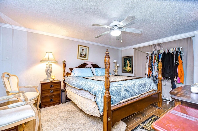 carpeted bedroom featuring ceiling fan, a textured ceiling, and ornamental molding