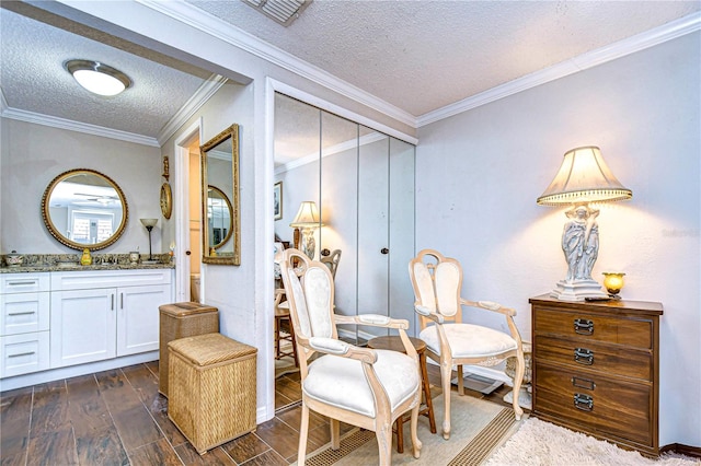 living area featuring a textured ceiling, crown molding, and dark wood-type flooring