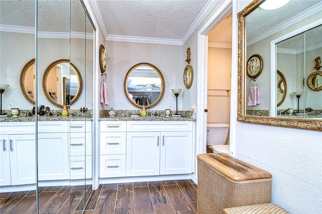 bathroom featuring crown molding, a textured ceiling, and hardwood / wood-style flooring