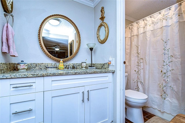 full bathroom with vanity, a textured ceiling, shower / bath combo with shower curtain, crown molding, and toilet