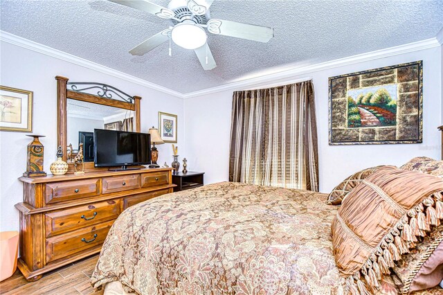 bedroom featuring ceiling fan, crown molding, a textured ceiling, and light wood-type flooring