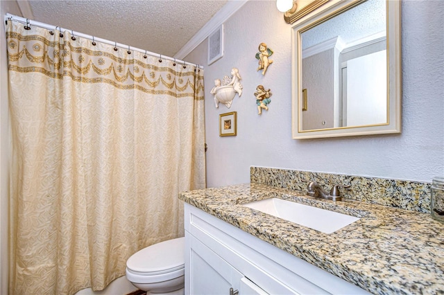 bathroom featuring vanity, toilet, and a textured ceiling