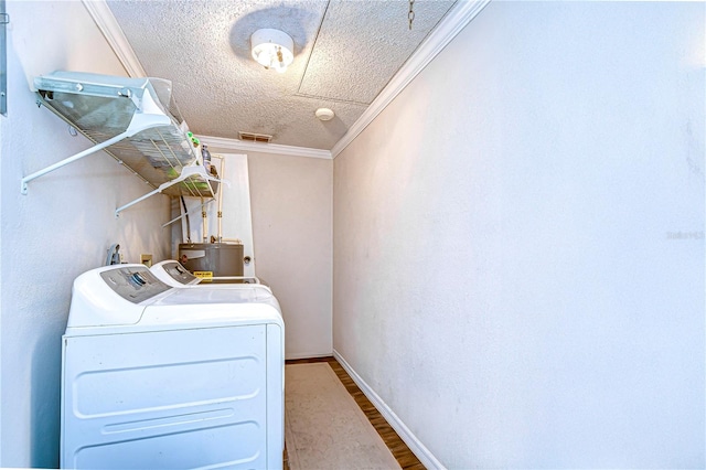 clothes washing area featuring hardwood / wood-style floors, washer and dryer, ornamental molding, a textured ceiling, and water heater