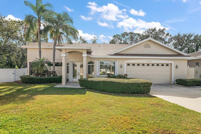 view of front of house featuring a garage and a front lawn