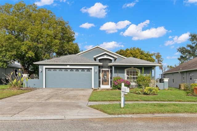 view of front of home with a garage and a front lawn