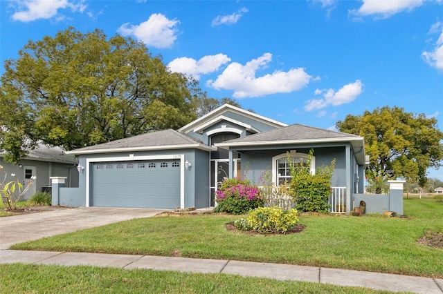 view of front of property featuring a front yard and a garage