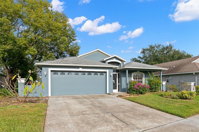 ranch-style house featuring a front yard and a garage