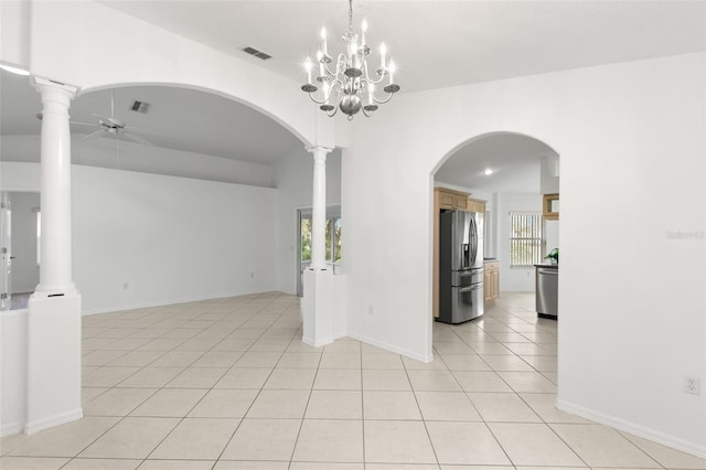 tiled empty room featuring ceiling fan with notable chandelier