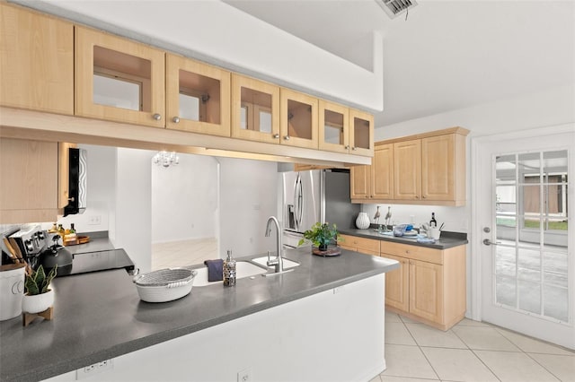 kitchen with sink, black stove, light brown cabinets, stainless steel fridge with ice dispenser, and light tile patterned floors