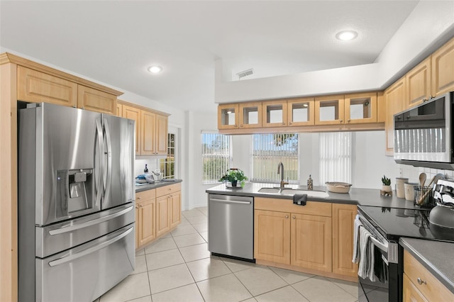 kitchen with light tile patterned floors, light brown cabinets, stainless steel appliances, and sink