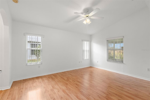 unfurnished room with ceiling fan, light hardwood / wood-style floors, and vaulted ceiling