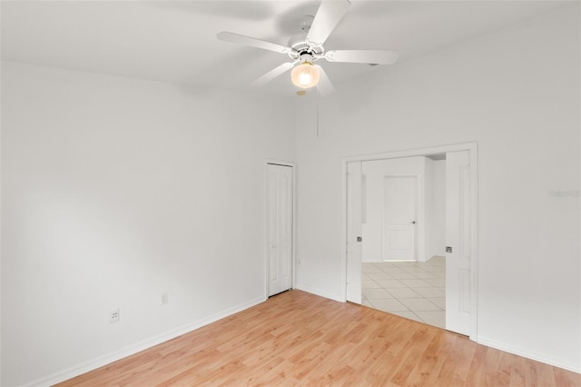 empty room featuring ceiling fan and light hardwood / wood-style flooring