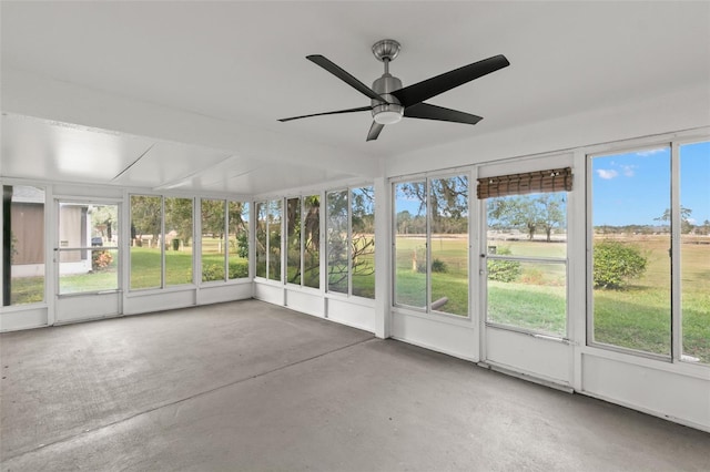 unfurnished sunroom featuring plenty of natural light and ceiling fan