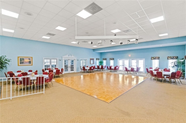 interior space with carpet flooring, french doors, and a paneled ceiling