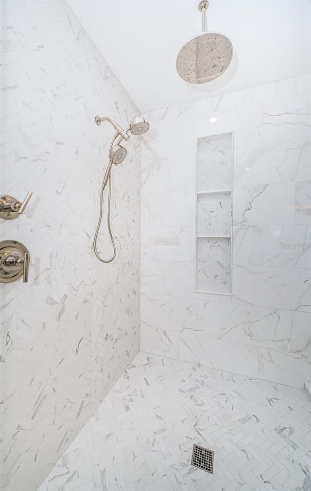 bathroom with a tile shower