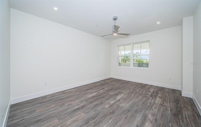 unfurnished room with ceiling fan and dark wood-type flooring