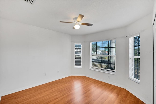 unfurnished room featuring hardwood / wood-style floors, ceiling fan, and a textured ceiling