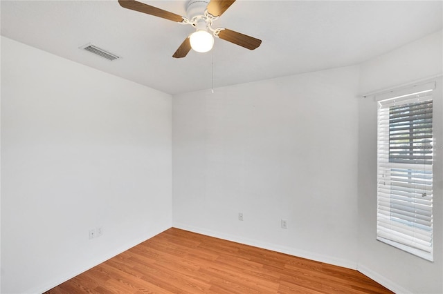 spare room with ceiling fan and wood-type flooring