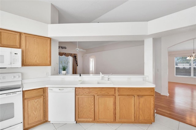 kitchen with ceiling fan with notable chandelier, white appliances, sink, and light tile patterned floors