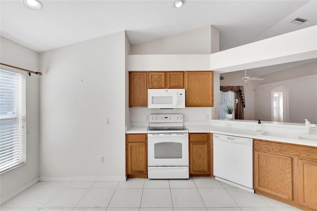 kitchen with lofted ceiling, ceiling fan, white appliances, and light tile patterned floors