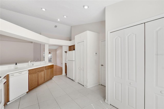 kitchen featuring white appliances and light tile patterned flooring