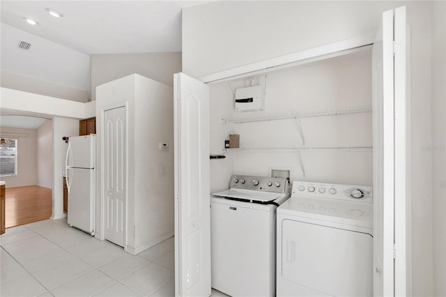 washroom featuring washer and dryer and light tile patterned floors