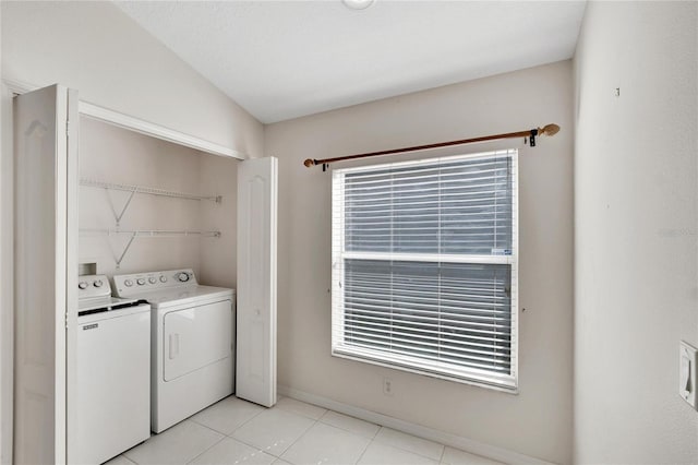 clothes washing area featuring independent washer and dryer and light tile patterned floors