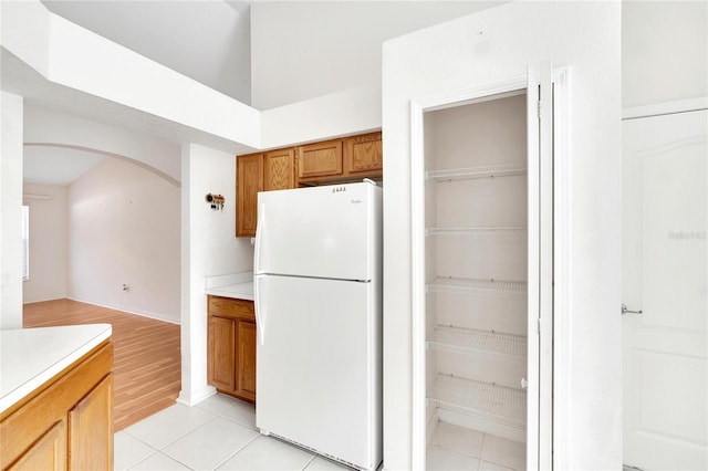 kitchen with light wood-type flooring and white fridge