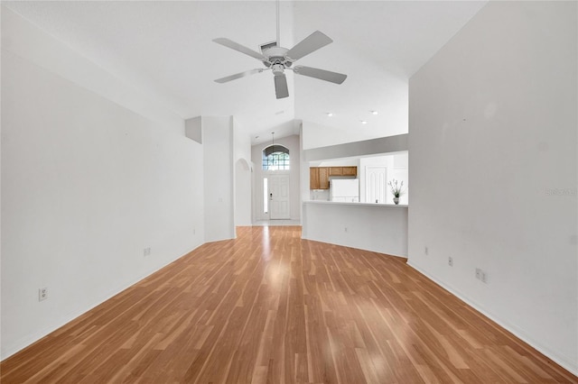 unfurnished living room featuring light hardwood / wood-style flooring, ceiling fan, and lofted ceiling