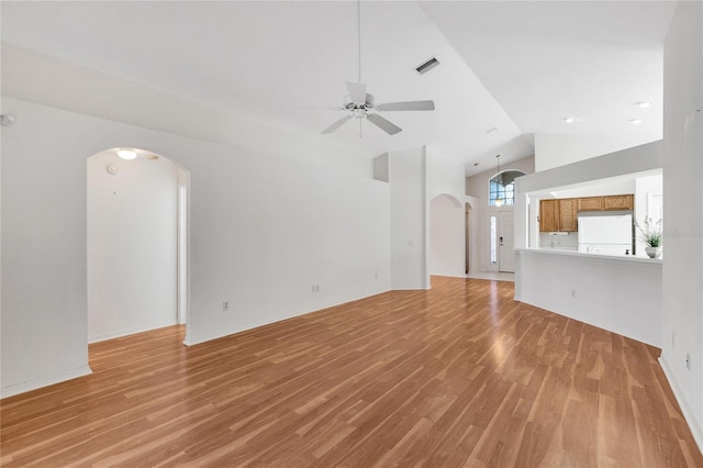 unfurnished living room with light wood-type flooring, high vaulted ceiling, and ceiling fan