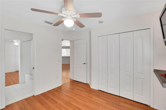 unfurnished bedroom with ceiling fan, a closet, and light hardwood / wood-style flooring