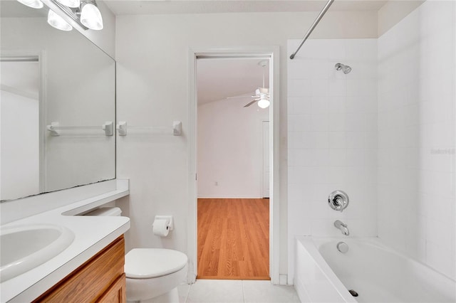 full bathroom with vanity, wood-type flooring, tiled shower / bath combo, and toilet