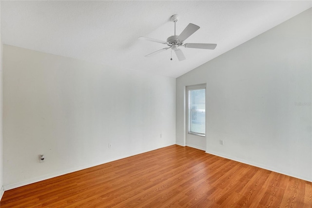 unfurnished room featuring light hardwood / wood-style floors, vaulted ceiling, and ceiling fan