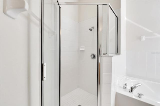 bathroom featuring separate shower and tub