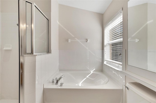 bathroom featuring separate shower and tub, toilet, and lofted ceiling