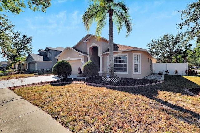 ranch-style house featuring a front yard and a garage