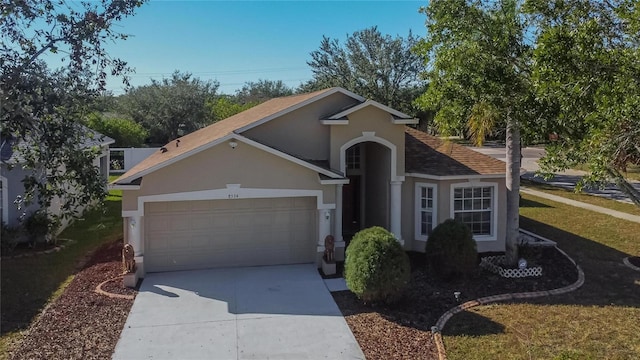 view of front of home with a garage and a front yard